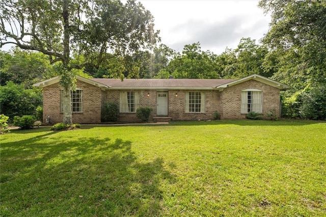 3163 Morgan Rd, Mobile, AL 36605 - ranch-style home featuring brick siding, a front lawn, and view of scattered trees