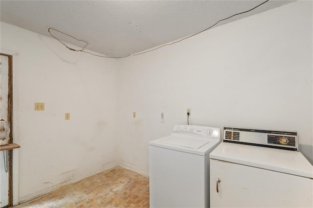 3163 Morgan Rd, Mobile, AL 36605 - washroom with washing machine and dryer, light wood-style flooring, and a textured ceiling