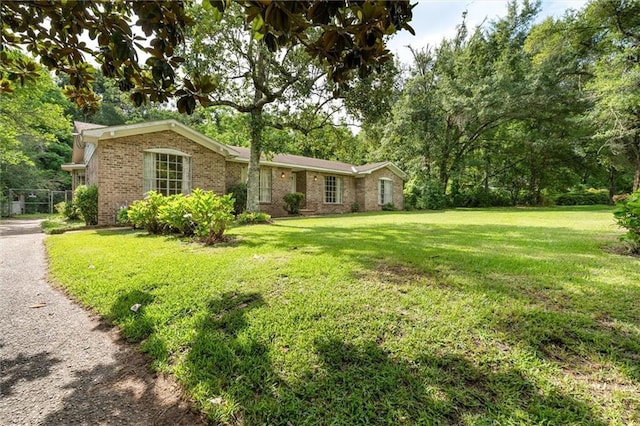 3163 Morgan Rd, Mobile, AL 36605 - ranch-style home with brick siding and a front lawn
