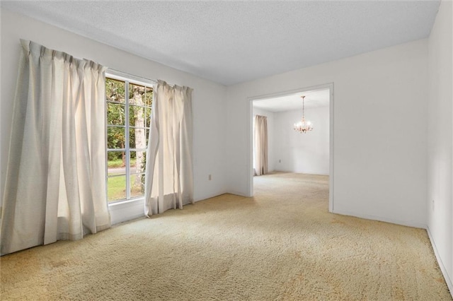 3163 Morgan Rd, Mobile, AL 36605 - spare room with carpet floors, a chandelier, healthy amount of natural light, and a textured ceiling