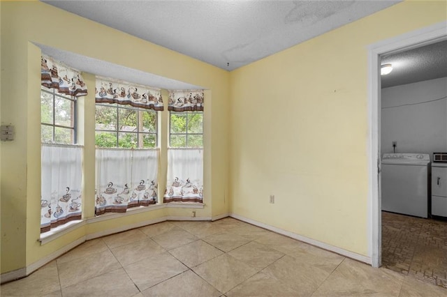 3163 Morgan Rd, Mobile, AL 36605 - tiled empty room featuring washer and clothes dryer and a textured ceiling