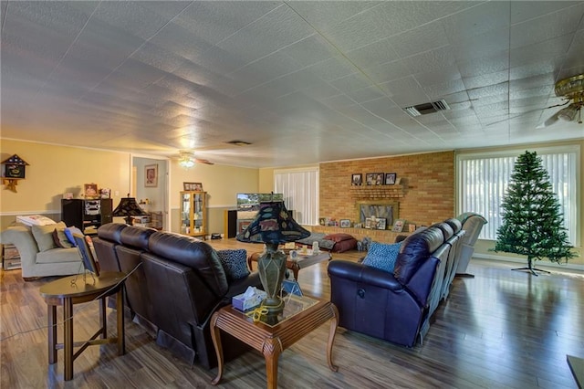 living room with a fireplace, hardwood / wood-style floors, and ceiling fan