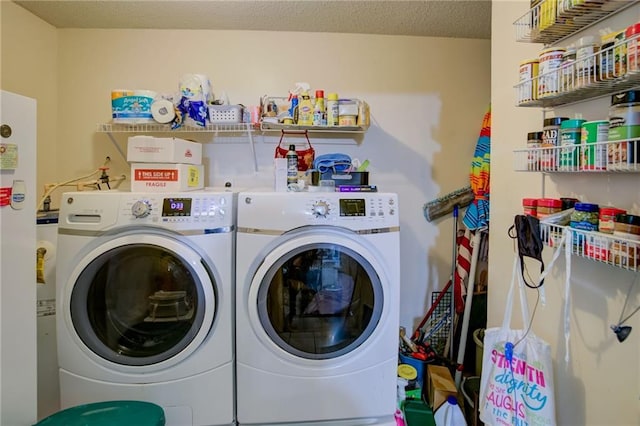 laundry area featuring a textured ceiling and washer and clothes dryer