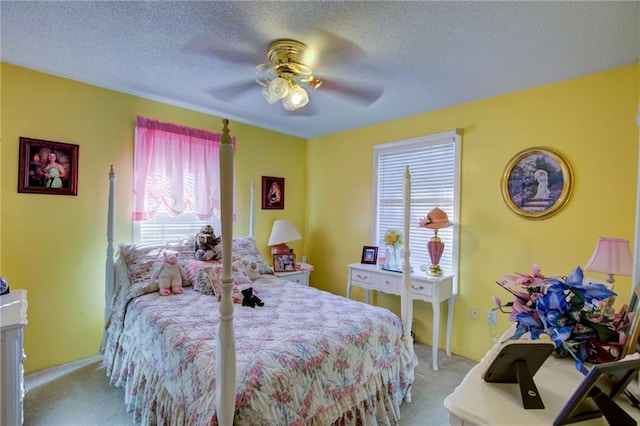 carpeted bedroom featuring multiple windows, a textured ceiling, and ceiling fan