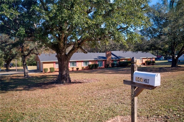 single story home with a front lawn