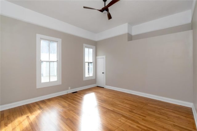 unfurnished room with hardwood / wood-style floors and ceiling fan