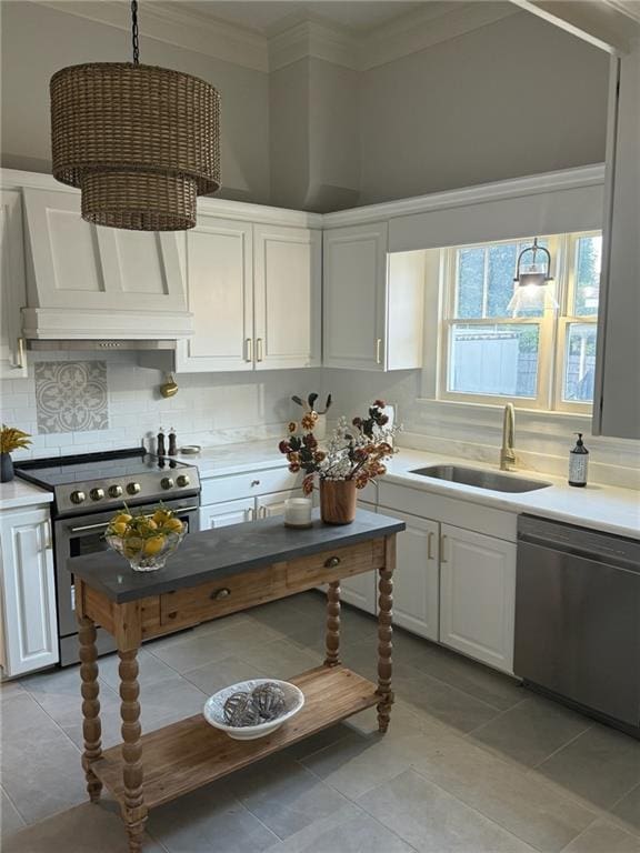 kitchen with hanging light fixtures, white cabinets, and electric range