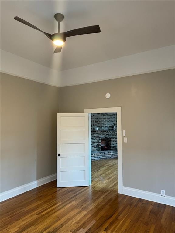 spare room featuring dark wood-type flooring and ceiling fan