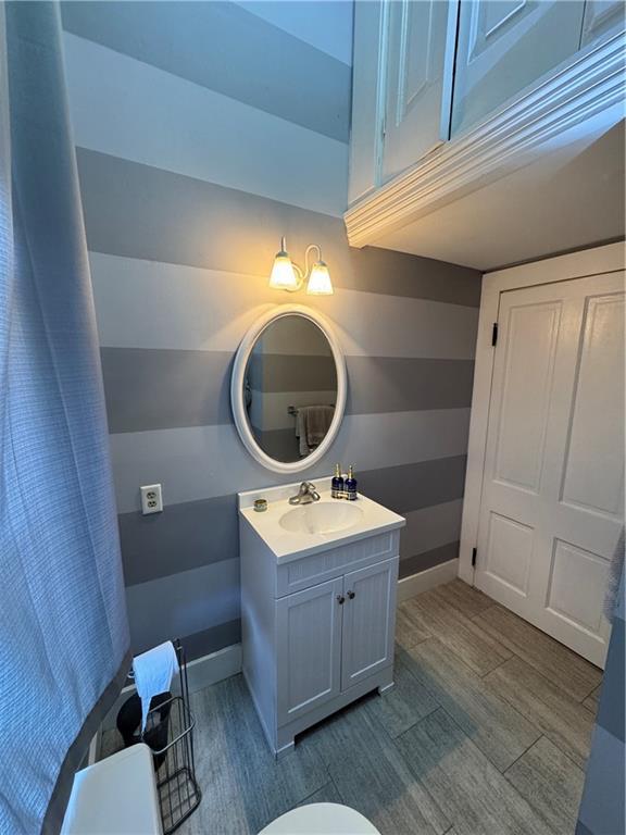 bathroom featuring vanity, hardwood / wood-style floors, and toilet