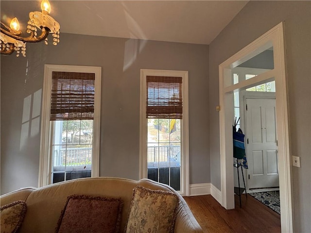 foyer with an inviting chandelier and hardwood / wood-style floors