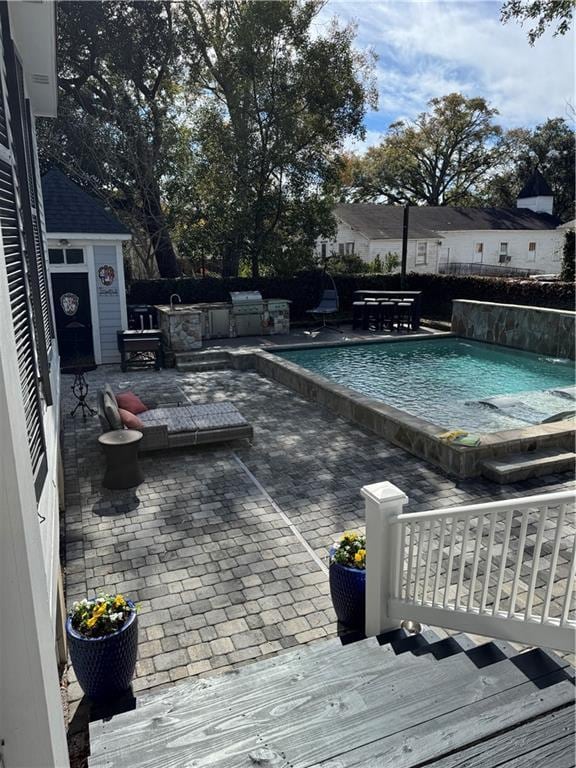 view of swimming pool with a patio