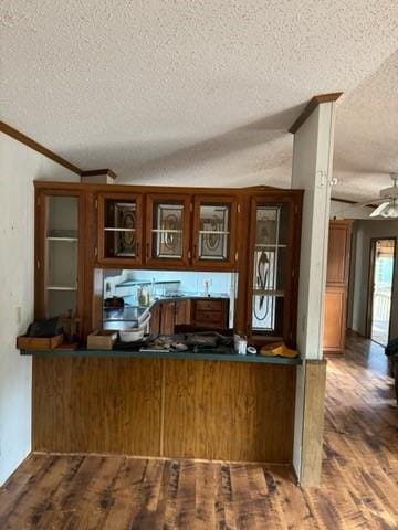 interior space with hardwood / wood-style floors, ornamental molding, a textured ceiling, and ceiling fan