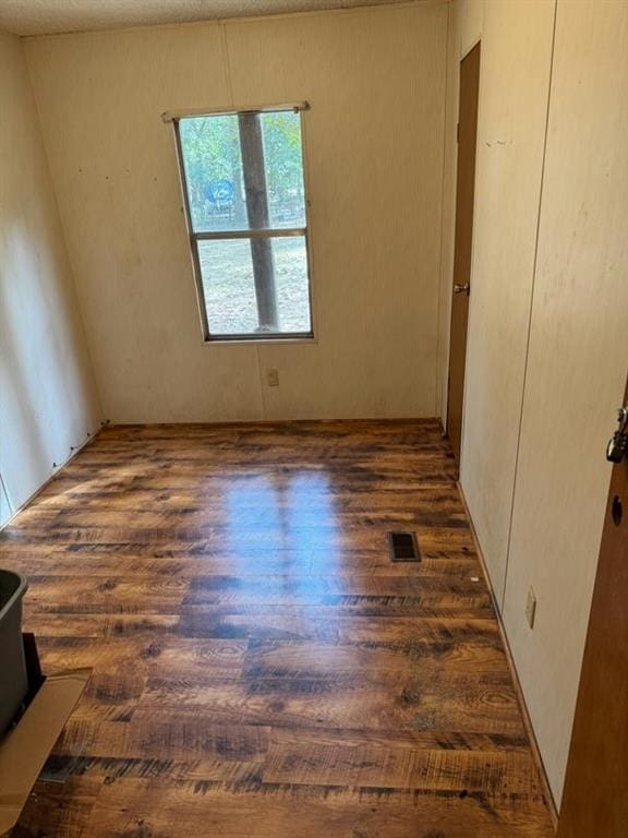 empty room with dark hardwood / wood-style floors