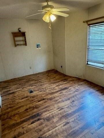 empty room with hardwood / wood-style flooring and ceiling fan