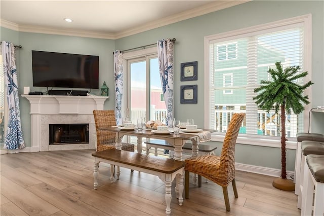 106 Serigny Ct, Dauphin Island, AL 36528 - dining area with wood finished floors, baseboards, crown molding, recessed lighting, and a fireplace