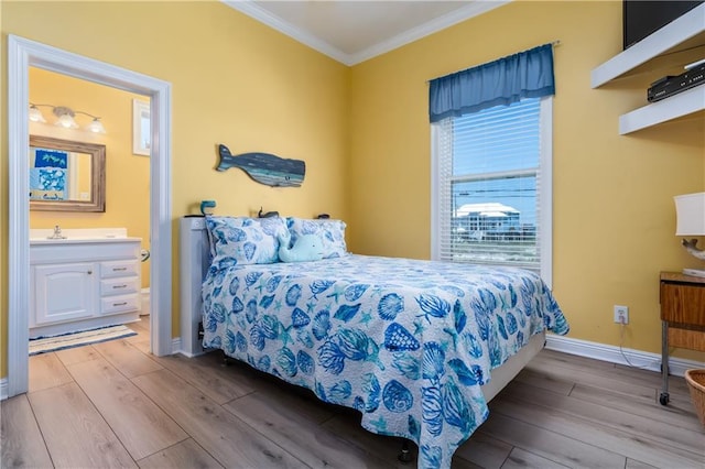 106 Serigny Ct, Dauphin Island, AL 36528 - bedroom with wood finished floors, crown molding, baseboards, ensuite bath, and a sink