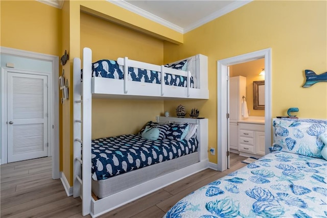 106 Serigny Ct, Dauphin Island, AL 36528 - bedroom with ornamental molding, light wood-type flooring, ensuite bath, and baseboards