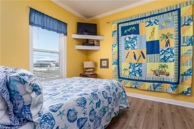 106 Serigny Ct, Dauphin Island, AL 36528 - bedroom featuring crown molding, wood finished floors, and baseboards