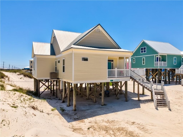 106 Serigny Ct, Dauphin Island, AL 36528 - back of property with a carport, stairs, and metal roof