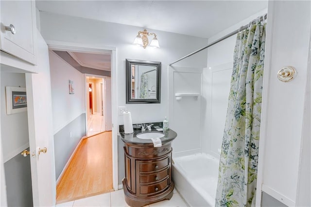 bathroom with vanity, wood finished floors, and shower / bathtub combination with curtain