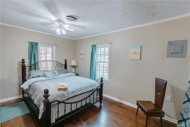 bedroom featuring multiple windows, wood finished floors, and baseboards