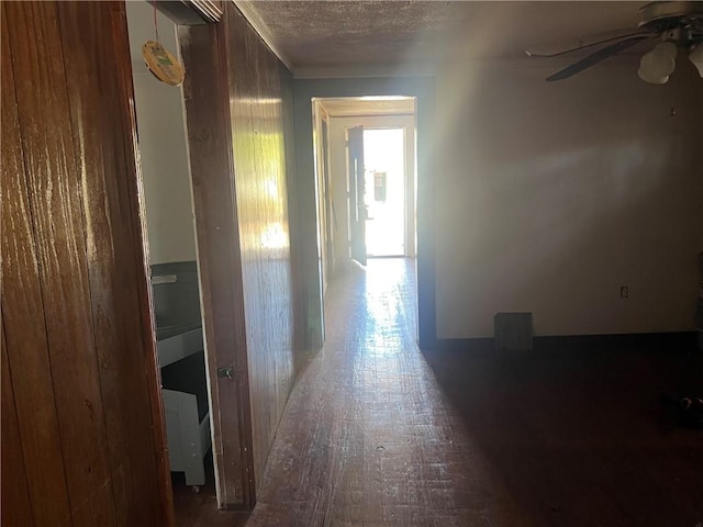 hallway with a textured ceiling