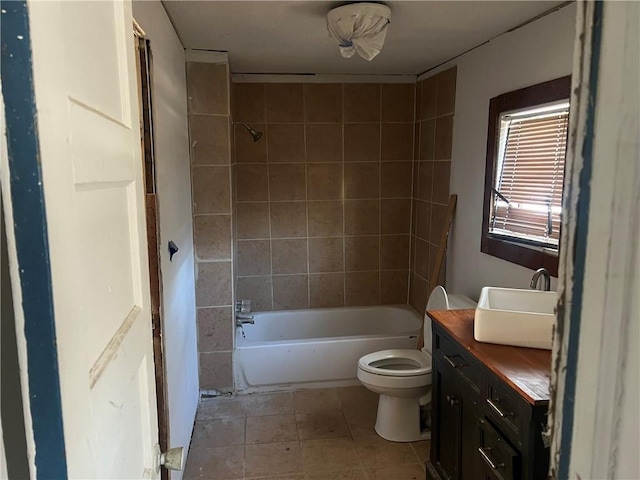 full bathroom with vanity, toilet, tiled shower / bath combo, and tile patterned flooring