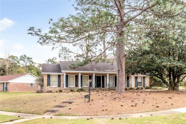 single story home with brick siding and covered porch