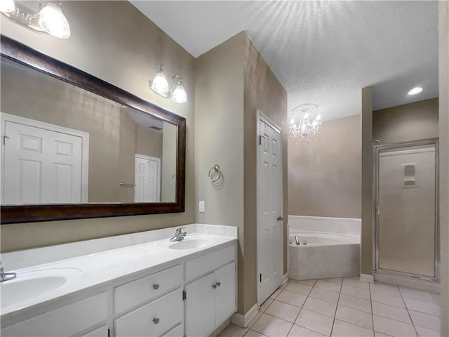 bathroom featuring a notable chandelier, tile patterned floors, a textured ceiling, shower with separate bathtub, and vanity