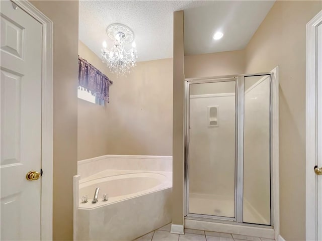 bathroom featuring a chandelier, shower with separate bathtub, a textured ceiling, and tile patterned floors