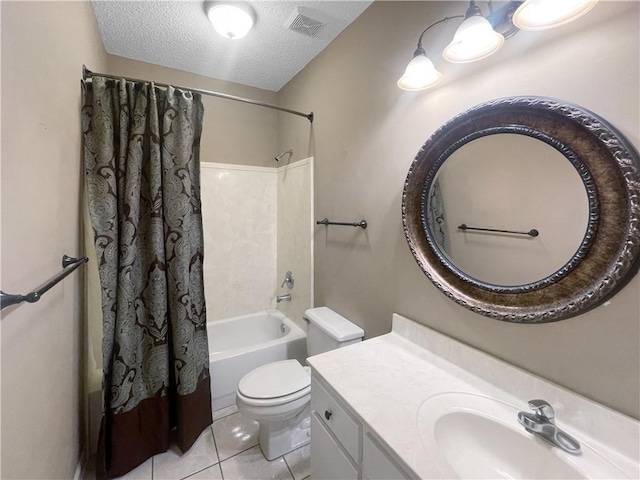 full bathroom with tile patterned floors, vanity, a textured ceiling, shower / bath combo with shower curtain, and toilet