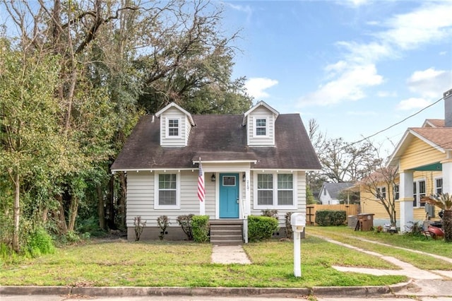 new england style home with a front yard and crawl space