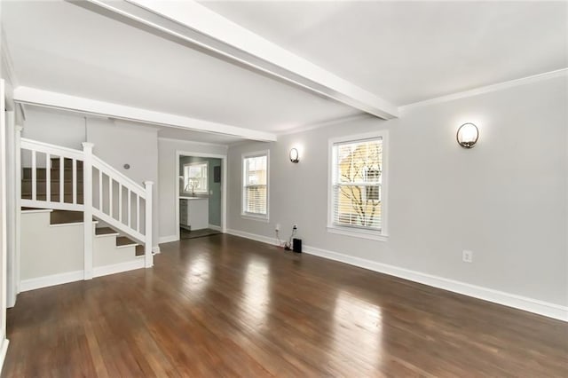 unfurnished living room with wood finished floors, baseboards, stairway, beam ceiling, and crown molding