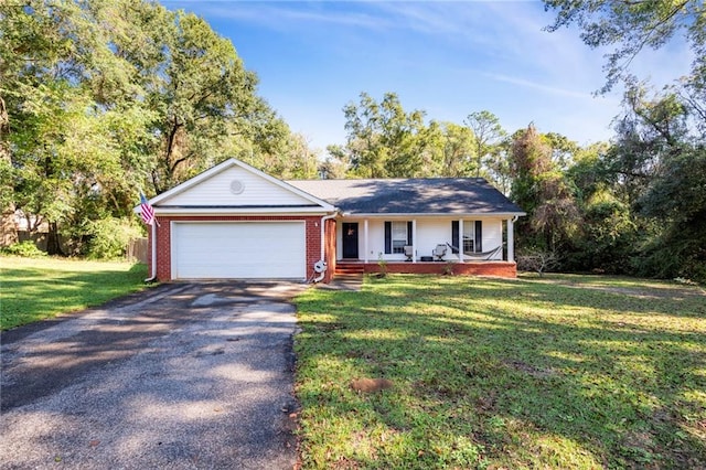 single story home with covered porch, a garage, and a front lawn