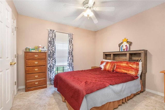 bedroom featuring light colored carpet and ceiling fan