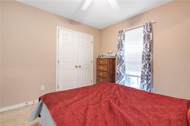 bedroom featuring ceiling fan, carpet floors, and a closet