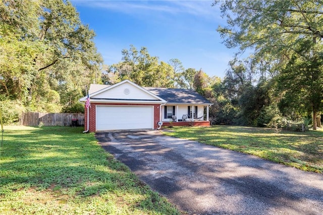 ranch-style house with a garage, a porch, and a front yard