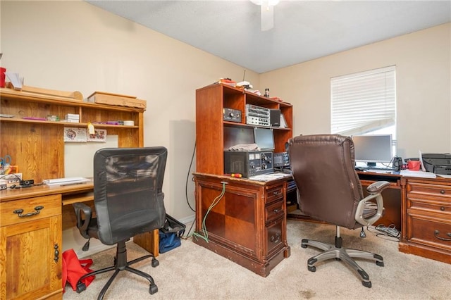 carpeted office space with ceiling fan