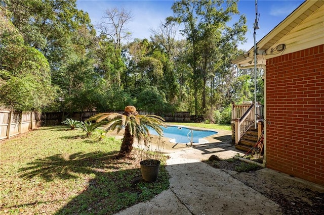 view of pool with a lawn and a patio area