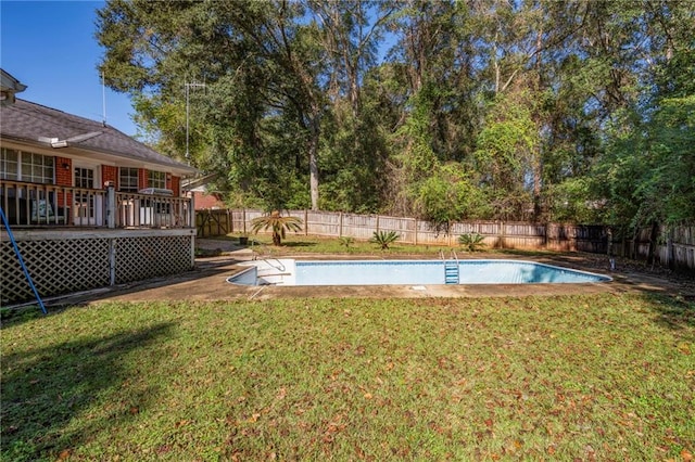 view of swimming pool featuring a yard and a deck