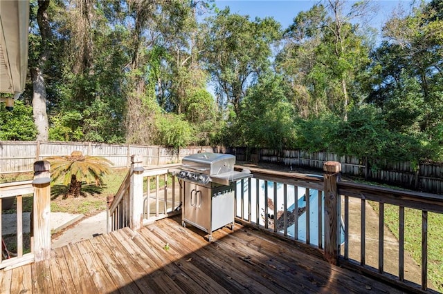 wooden terrace with a grill