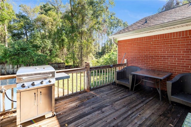 wooden deck featuring area for grilling