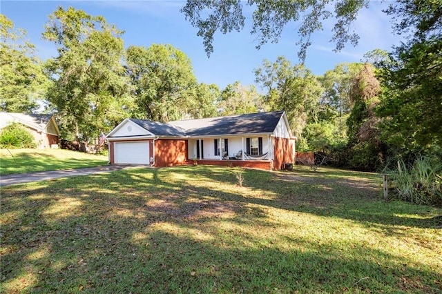 single story home featuring a garage, covered porch, and a front yard