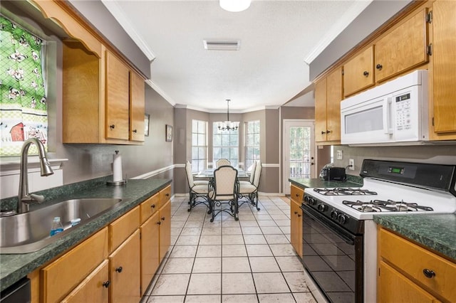 kitchen featuring ornamental molding, white appliances, sink, light tile patterned floors, and an inviting chandelier