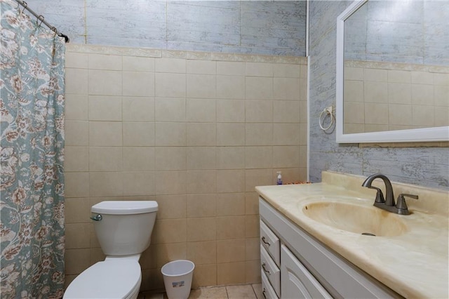 bathroom featuring vanity, tile walls, toilet, and tile patterned floors