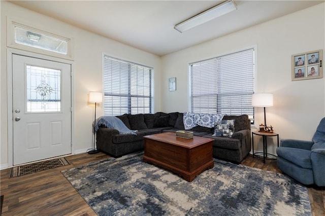 living area featuring baseboards and wood finished floors