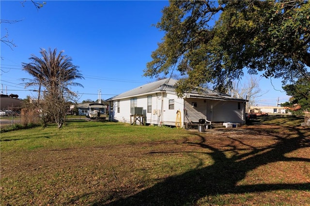 rear view of house with a lawn