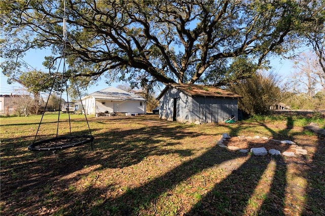 view of yard with a storage shed and an outdoor structure