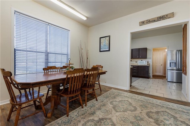 dining room featuring baseboards and light wood-style floors