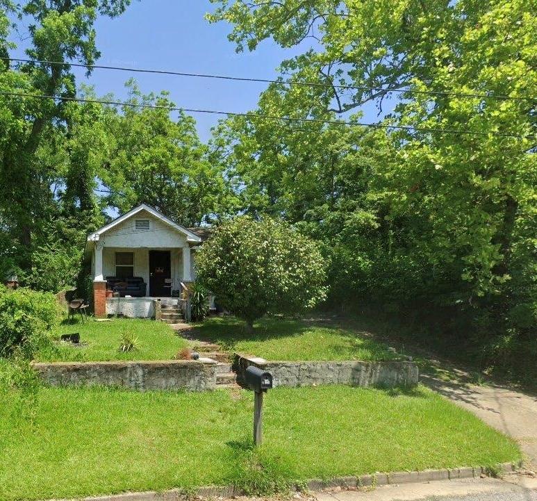 view of front of property with covered porch and a front yard